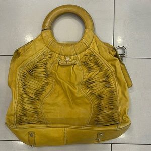Gustto yellow leather purse.